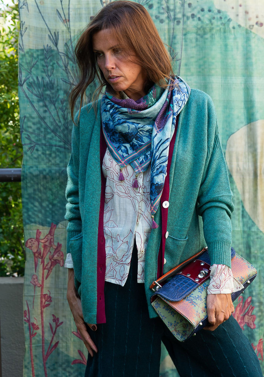 Printed white shirt, turquoise cardigan and scarf.